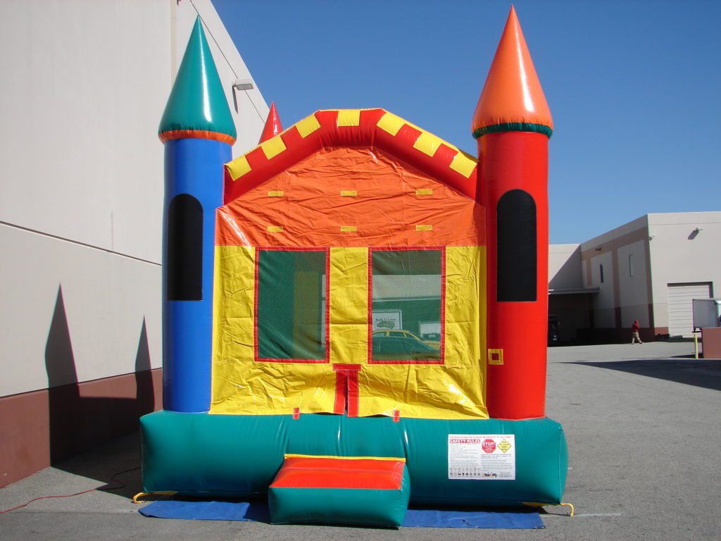 A colorful castle bounce house with blue, yellow and red accents.