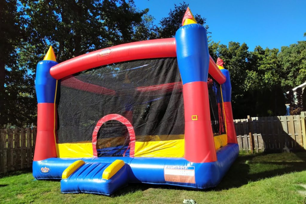 A large inflatable castle in the middle of a yard.