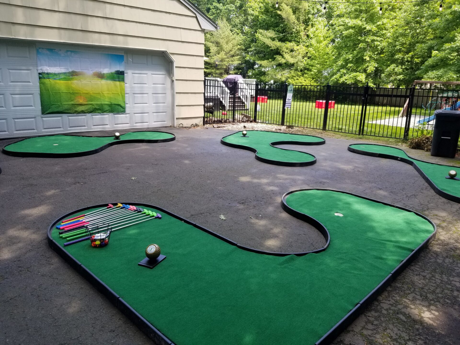 A mini golf course set up in a backyard.