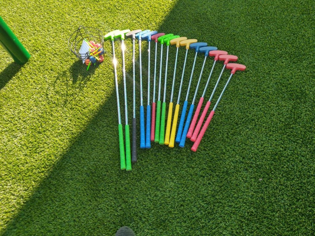 A group of colorful plastic sticks on the grass.